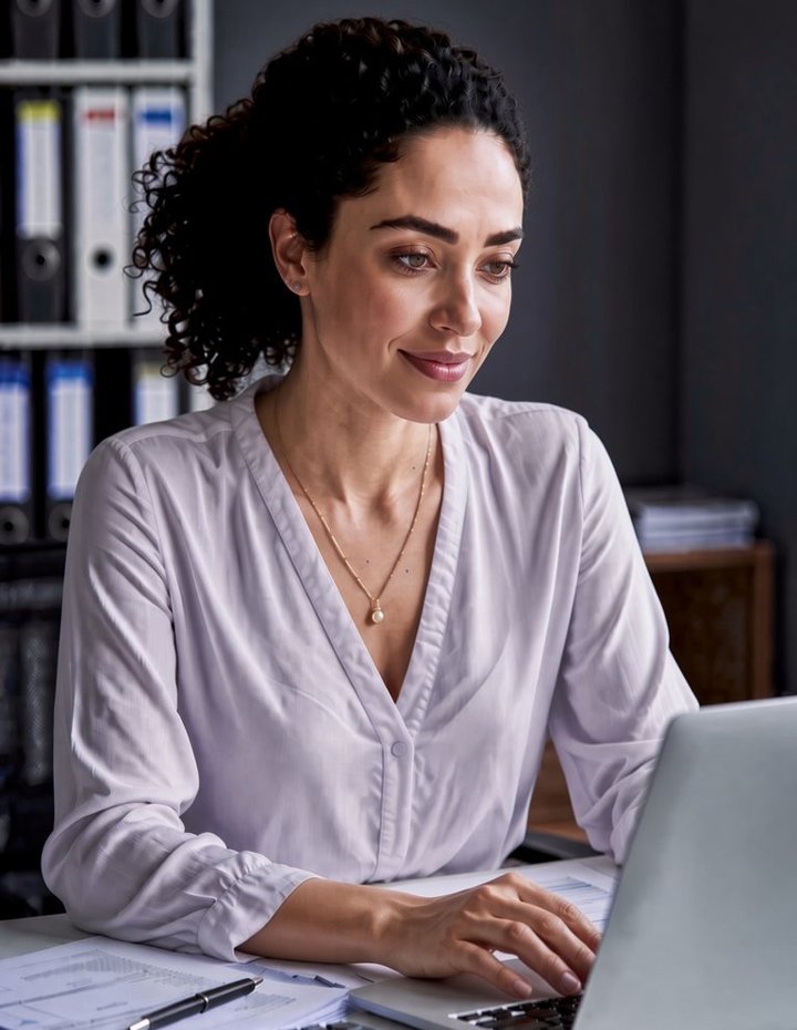 Reassessing internal controls and reviewing documentation at a laptop